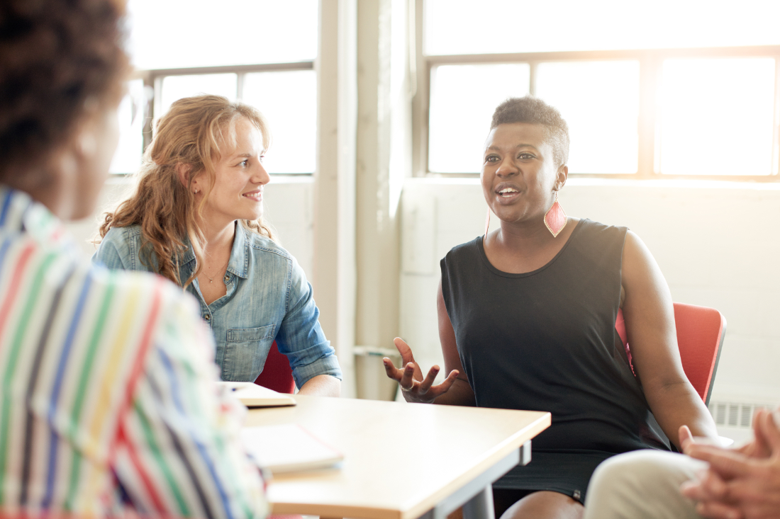 Women sitting at table having a conversation at a Leicester Carers learning session
