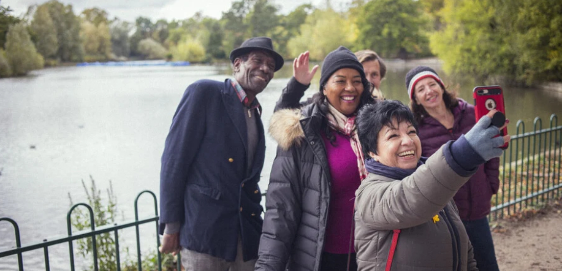 Group of friends taking a selfie in a park